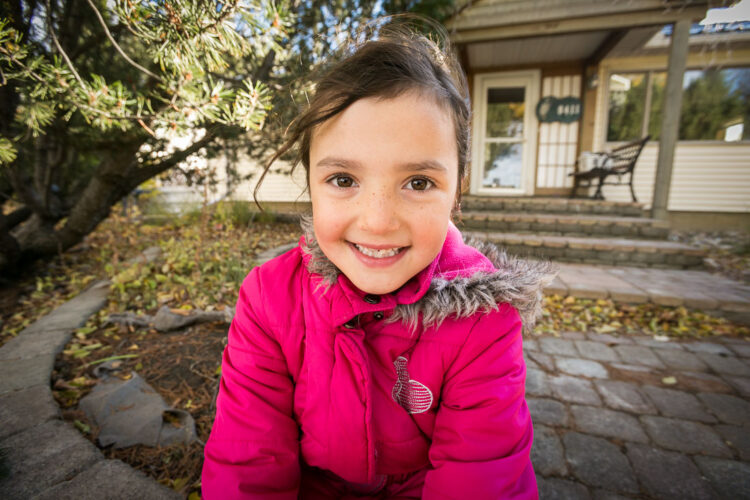 a portrait of a young girl taken with a 16mm camera lens to compare with a long telephoto lens portrait