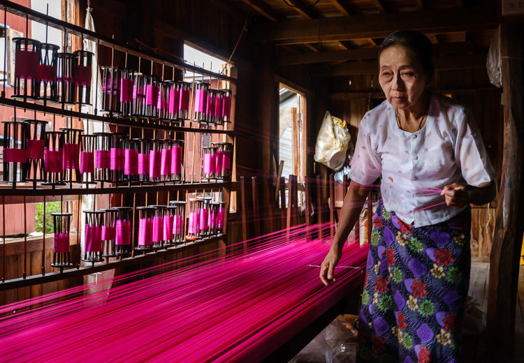 Burmese woman working textiles at Inle Lake Myanmar