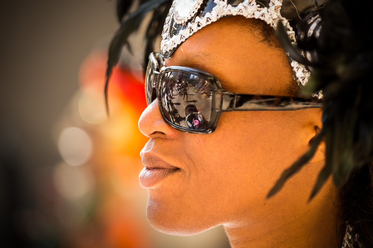 Aperture priority mode used in this photo of a caribbean festival participant due to changing lighting conditions