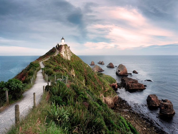 a path to the lighthouse creates leading lines that connect the viewer to the subject