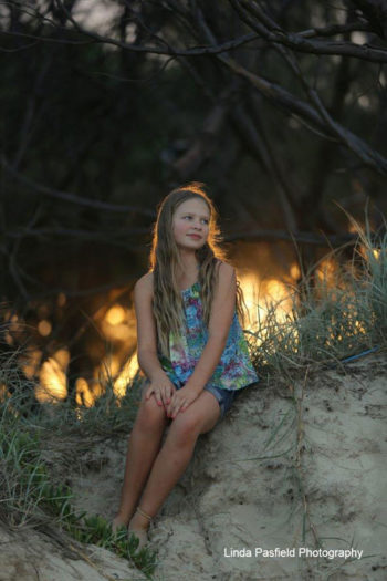 camera shy teen poses for her portrait photo