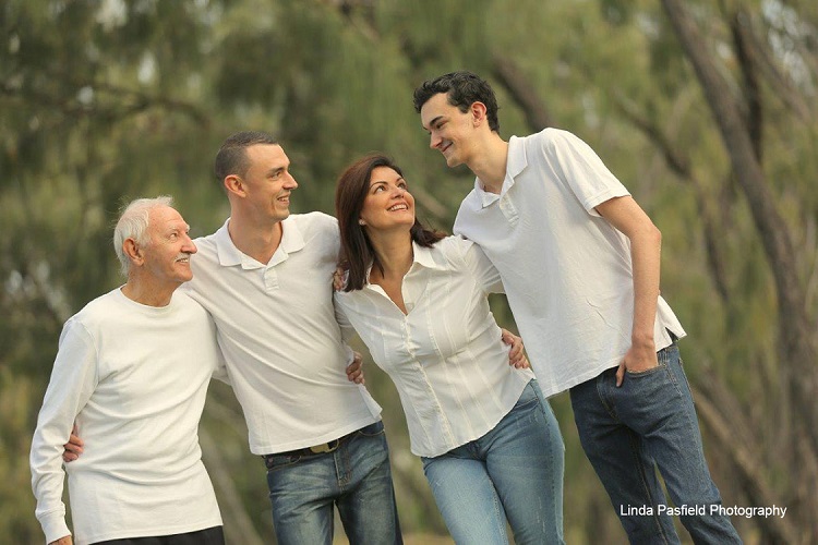 happy family poses for their portrait outdoors