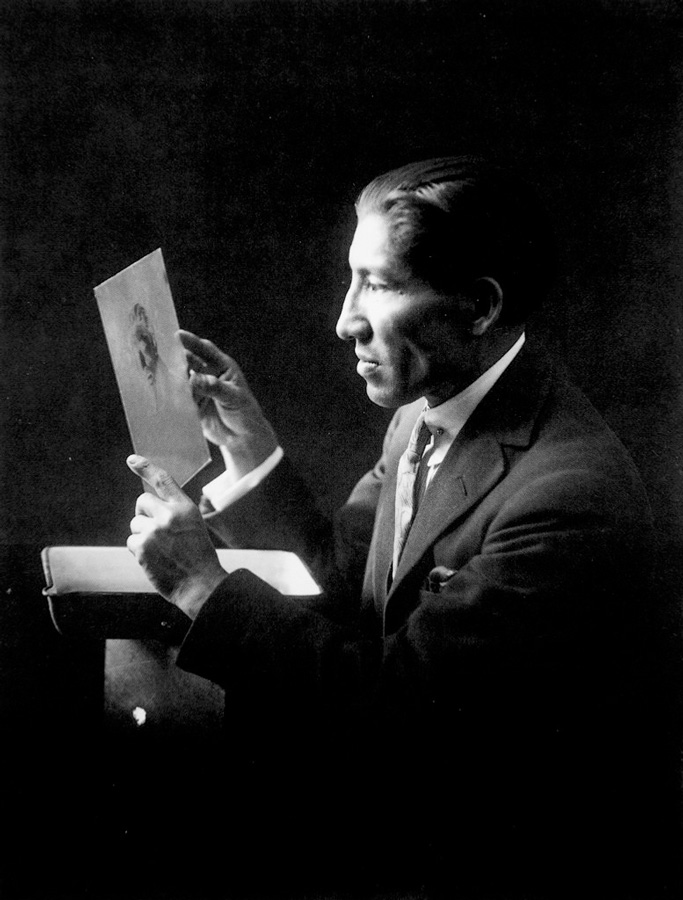 historical photo of portrait photographer Marin Chambi with a glass plate negative as a self portrait