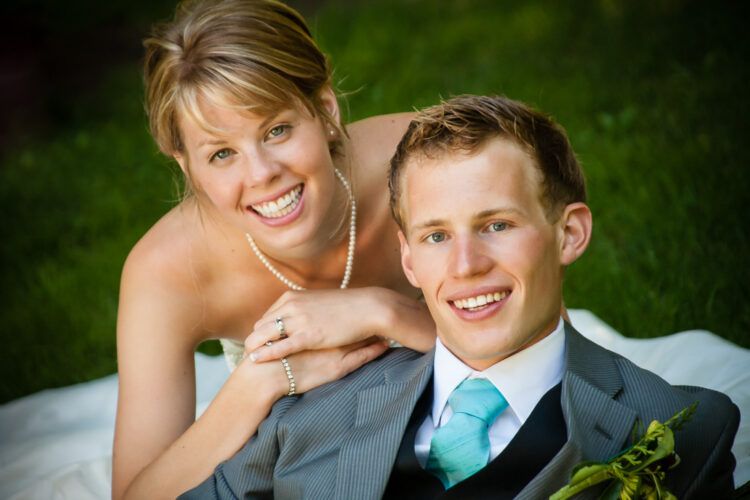 A classic wedding photo portrait of bride and groom using a 150mm long lens gives a soft background where the people are featured