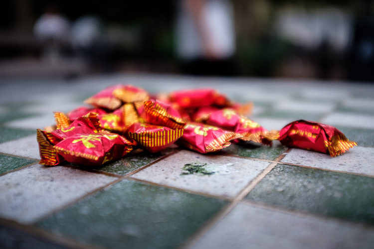 Some colorful candies placed on a checkered board becomes a creative example of close up photo