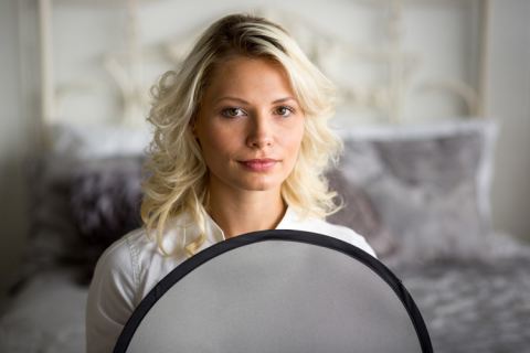 Professional model holding a gray card