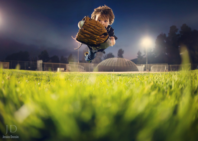 second shot of boy flying through the air to catch a baseball