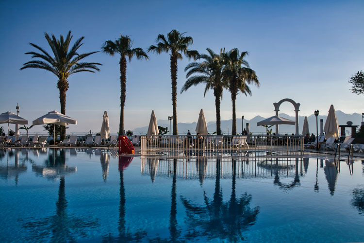 Swimming pool on the coast of Turkey with palm trees before edits