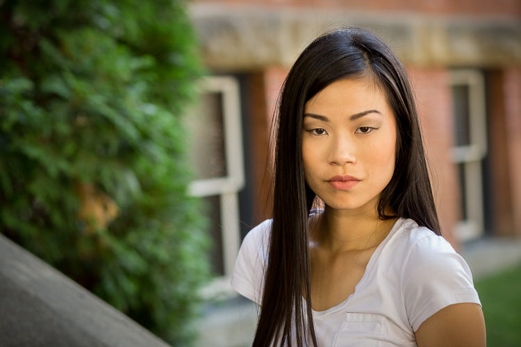 Shot at the same time of day but in the shade. See how much more flattering soft light is for her, and the background is more even as well.