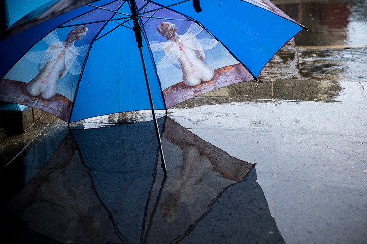 Street photograph of an umbrella in the rain in Vinales Cuba