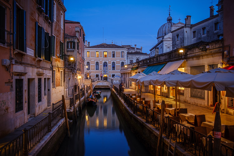 venice at night showing calm water on the canal