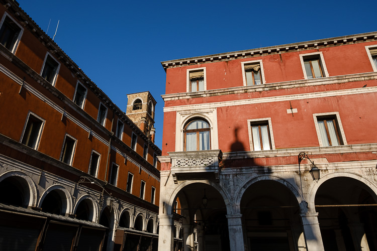 brick buildings showing their color against blue sky