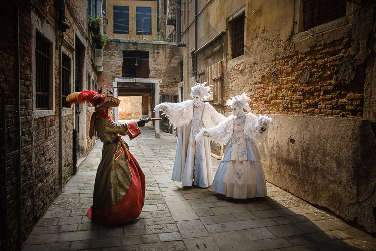 Pirate character points faux gun and acts as if they are robbing the bird characters