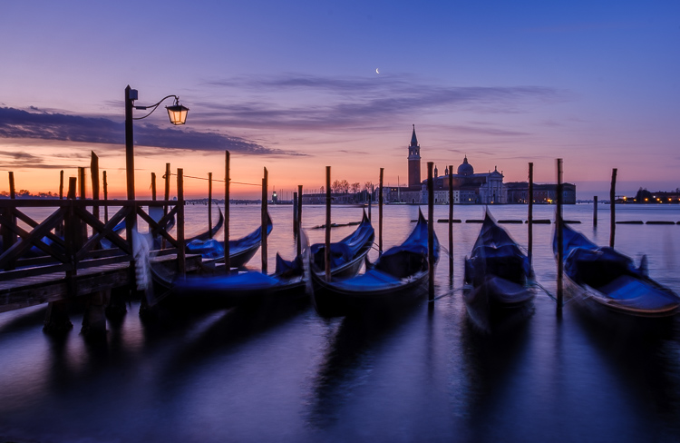 iconic photo of venice with gondolas floating in the water with St. George's Cathedral in the distance