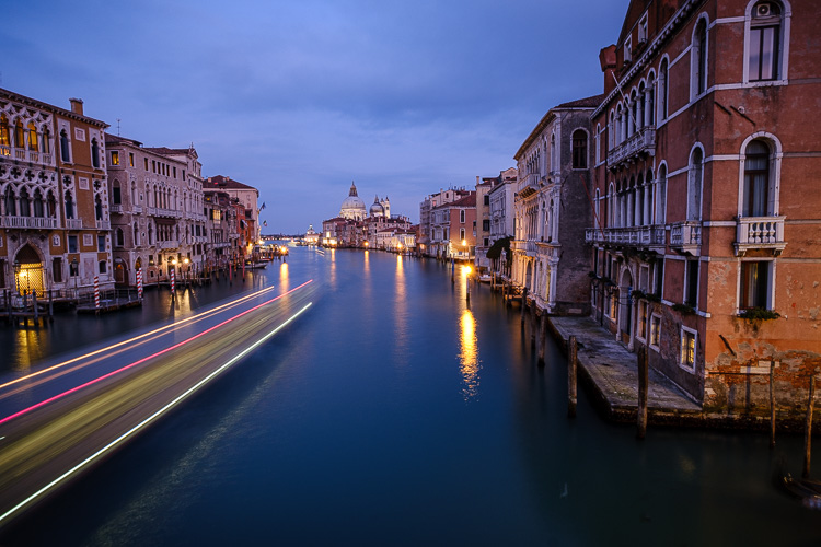 boat light trails at night in the venice canal