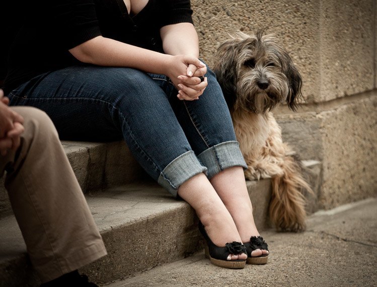 a woman and her dog sit and show their feet