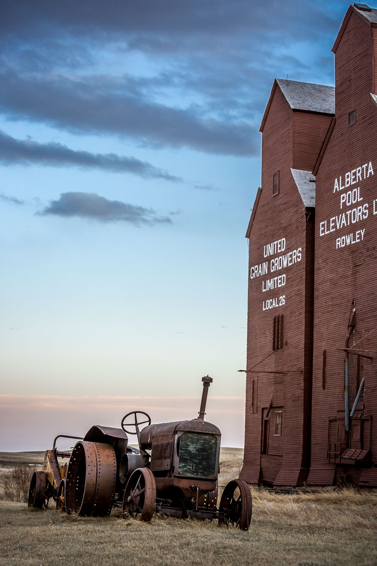 Same scene with tractor and grain elevators shot with a longer lens changes the perspective