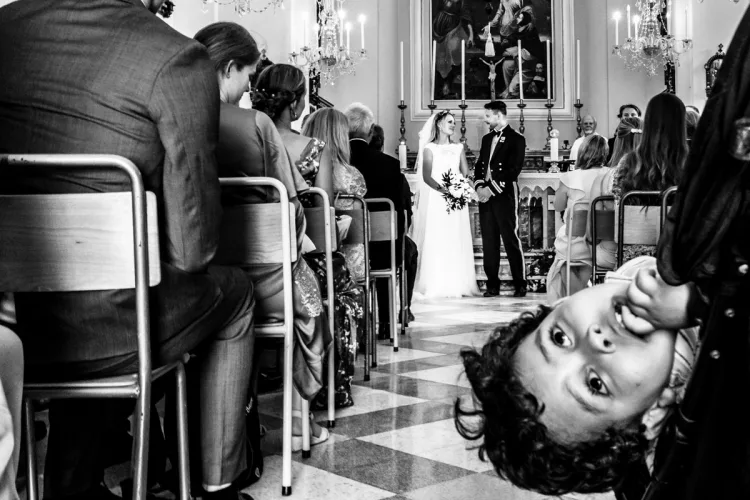 Wedding couple photographed down the isle using a prime lens for a different style